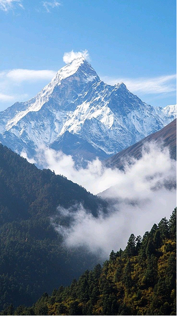 Snowy mountain peak with valley clouds