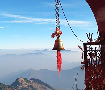 Temple bell overlooking a foggy mountain range